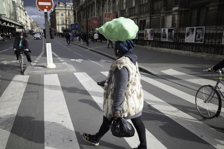 Woman Carrying Bag on Head on Zebra Crossing